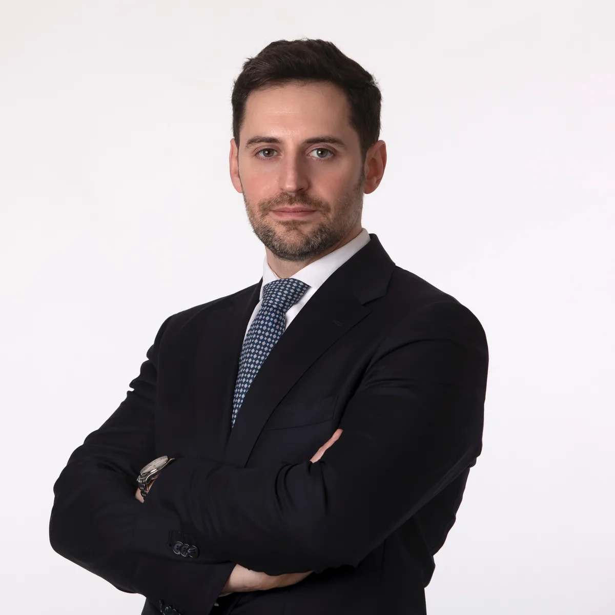 Ritratto professionale di un uomo in abito scuro con cravatta a pois, foto profilo LinkedIn a Milano