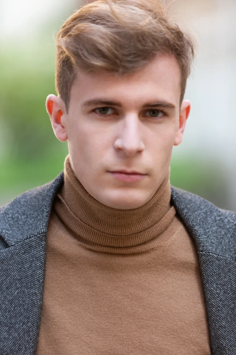 Headshot neutro di giovane attore con dolcevita cammello, book fotografico attori a Milano